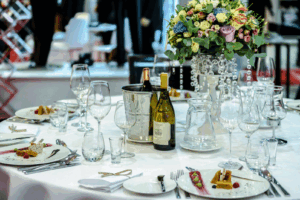 A table set with wine and glasses on it.