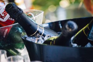 A bottle of wine is in an ice bucket.